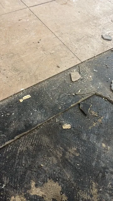 Black bitumen mastic floor removal in a EC1 flat